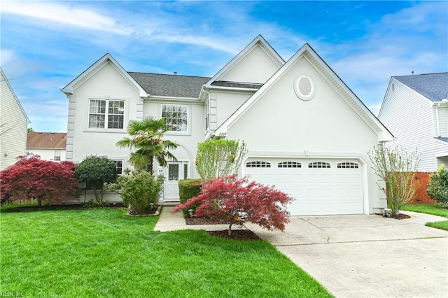 view of front facade featuring stucco siding, a front yard, fence, an attached garage, and concrete driveway