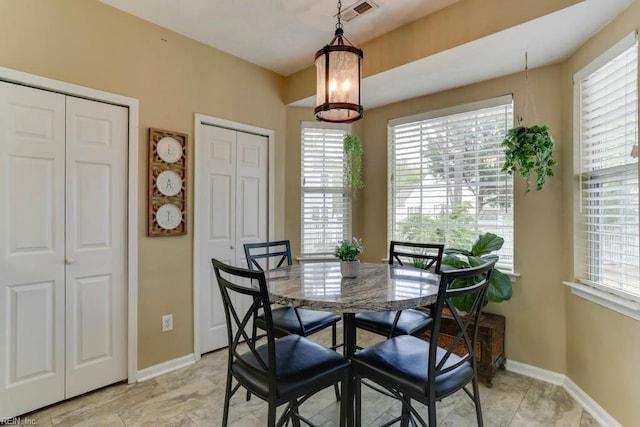 dining space with baseboards and visible vents