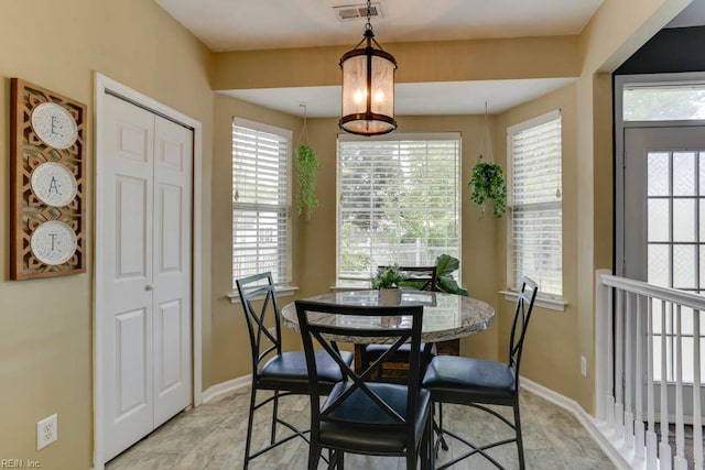 dining area featuring baseboards and visible vents