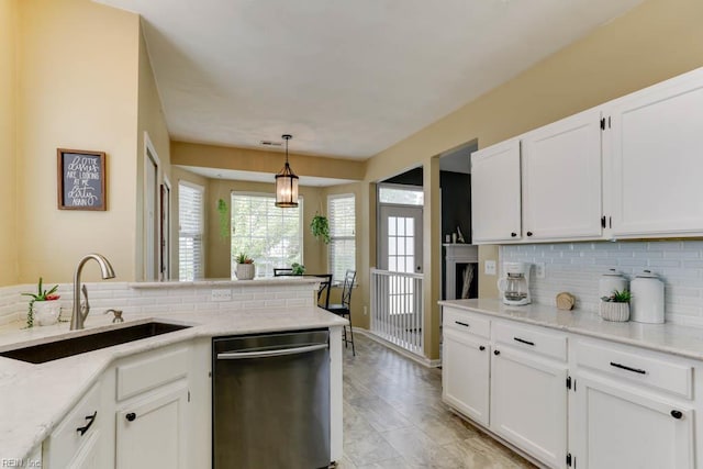 kitchen with white cabinetry, dishwasher, a sink, and backsplash