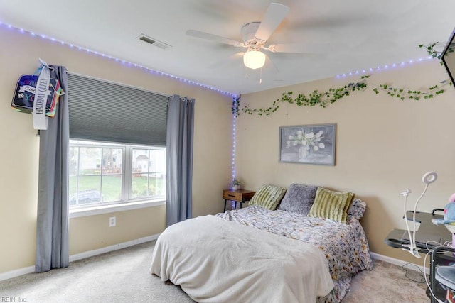 carpeted bedroom featuring visible vents, baseboards, and a ceiling fan