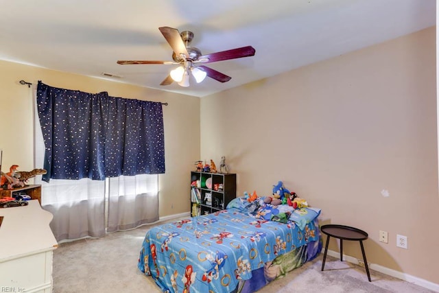 carpeted bedroom with visible vents, baseboards, and ceiling fan