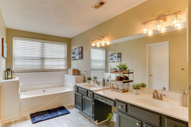 bathroom featuring a sink, visible vents, a bath, and double vanity