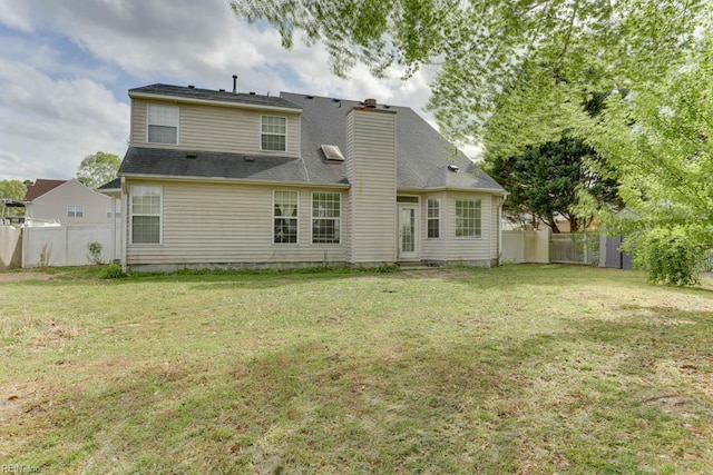 back of property featuring a yard, fence, and a chimney