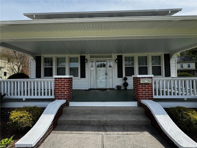 doorway to property featuring covered porch