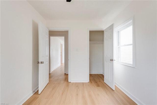 2325 Cottage Ave, Norfolk, VA 23504 - unfurnished bedroom featuring a closet, light wood-style flooring, and baseboards
