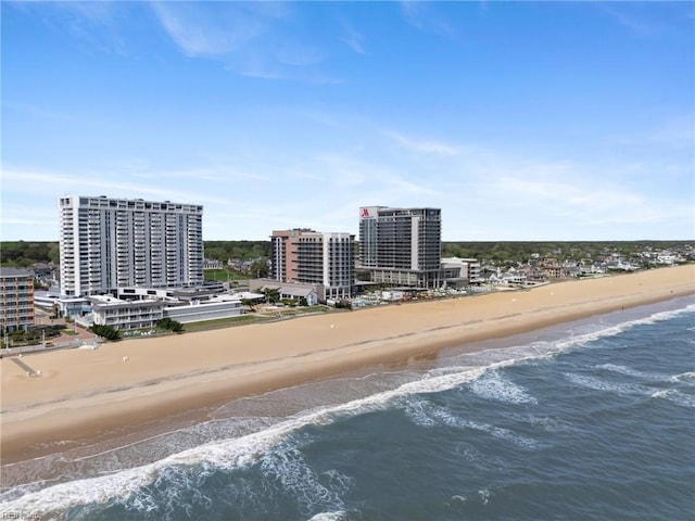 birds eye view of property with a view of the beach and a water view