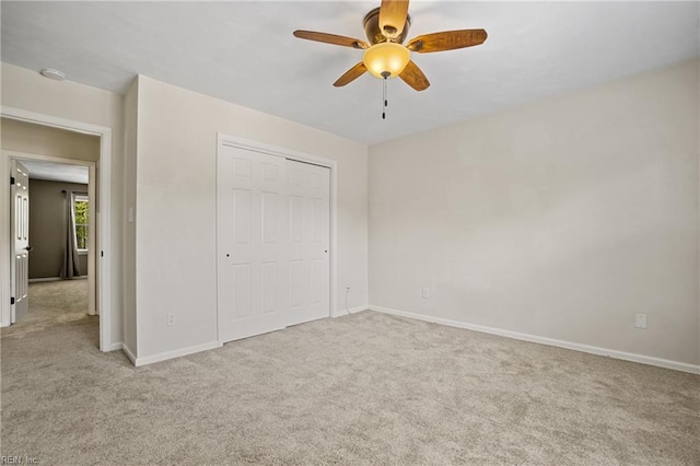 unfurnished bedroom with a closet, baseboards, and carpet