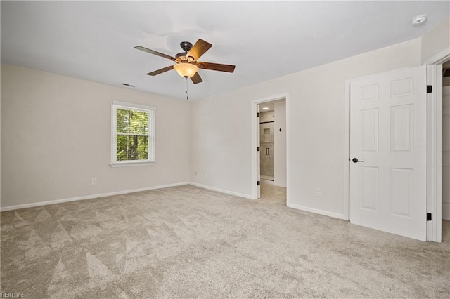 unfurnished bedroom with baseboards, connected bathroom, visible vents, ceiling fan, and carpet