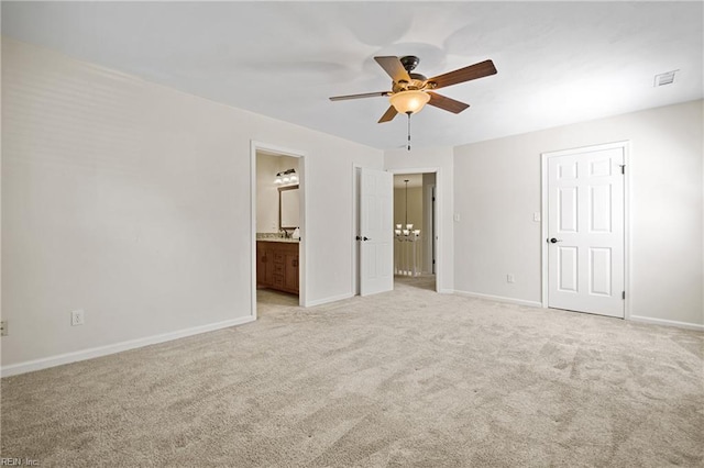 unfurnished bedroom featuring ceiling fan, ensuite bathroom, light colored carpet, visible vents, and baseboards