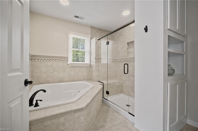 bathroom featuring a shower stall, a bath, tile patterned flooring, and visible vents