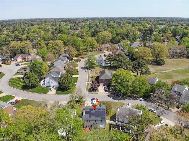 drone / aerial view featuring a view of trees and a residential view