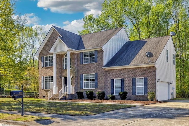 view of front of property with concrete driveway, brick siding, a front lawn, and an attached garage
