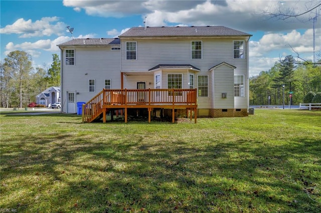 rear view of property featuring stairway, a deck, and a lawn