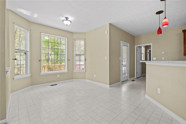unfurnished room featuring baseboards
