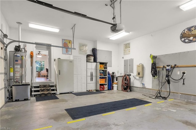 garage with electric panel, ceiling fan, freestanding refrigerator, gas water heater, and a garage door opener
