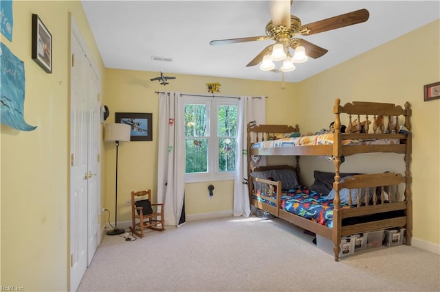 bedroom featuring carpet flooring, visible vents, baseboards, and ceiling fan