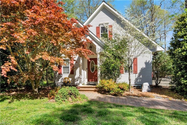obstructed view of property with a front lawn and fence