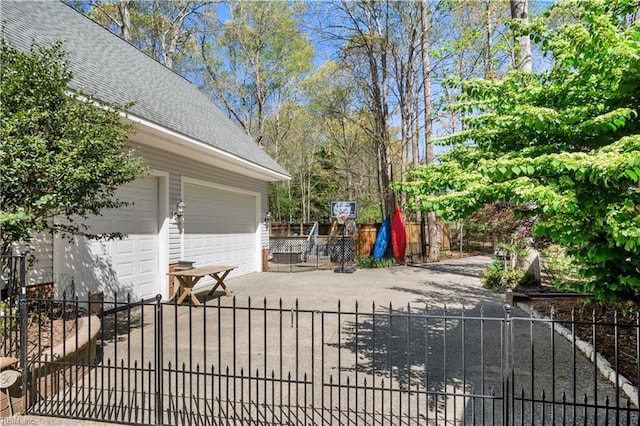view of patio / terrace with fence and driveway