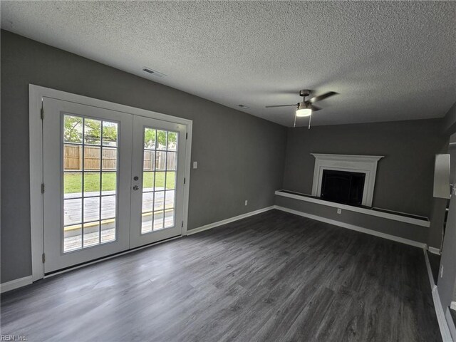 unfurnished living room featuring a ceiling fan, french doors, baseboards, and dark wood finished floors