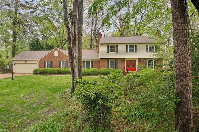 colonial house with a garage, a chimney, french doors, a front lawn, and driveway