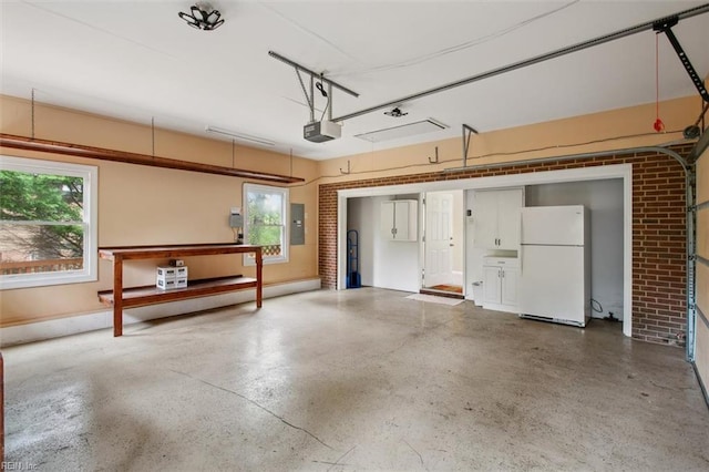 garage with electric panel, a garage door opener, and freestanding refrigerator