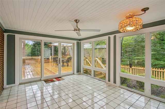 unfurnished sunroom featuring tile patterned flooring, plenty of natural light, wooden ceiling, and ceiling fan
