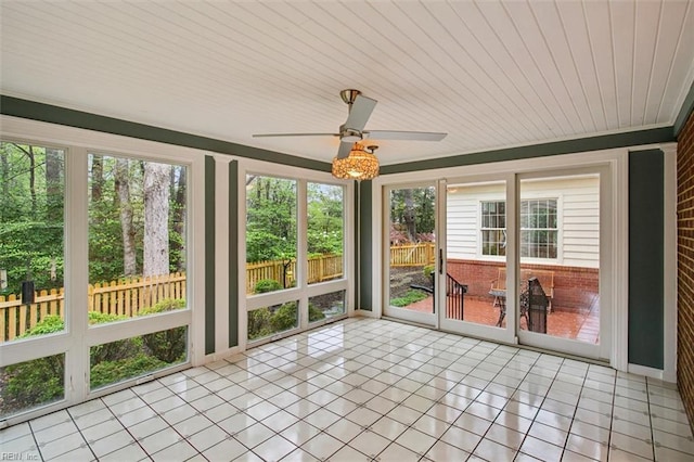 unfurnished sunroom featuring a healthy amount of sunlight, tile patterned flooring, and wooden ceiling