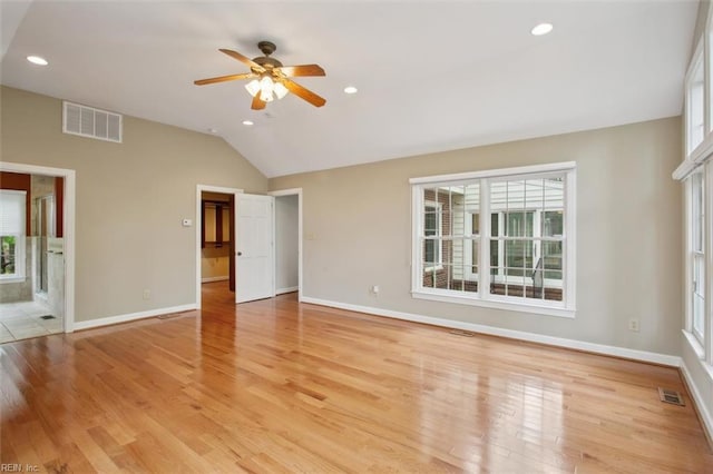 unfurnished living room featuring visible vents, baseboards, a ceiling fan, and vaulted ceiling