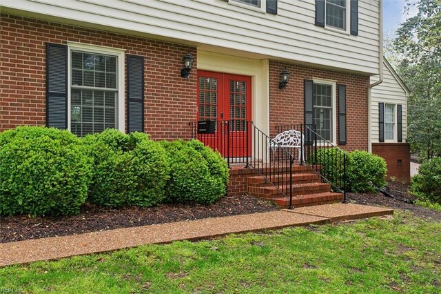 view of exterior entry featuring brick siding