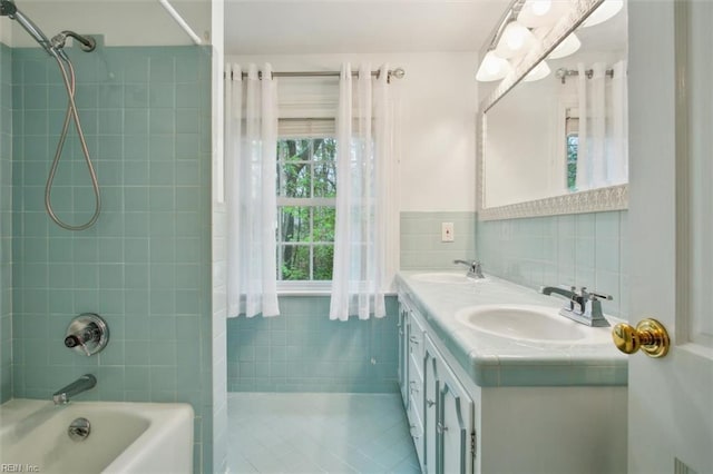 bathroom featuring a sink, tile walls, bathtub / shower combination, and double vanity