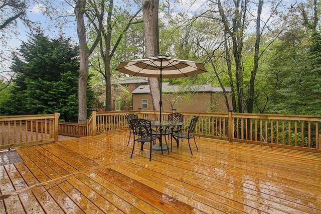 wooden deck featuring outdoor dining area
