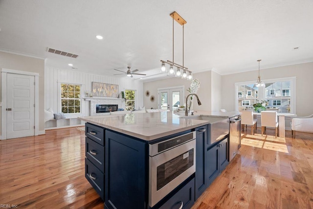kitchen with visible vents, a sink, ceiling fan, appliances with stainless steel finishes, and french doors