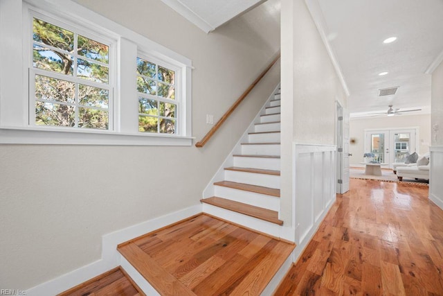 stairway with wood finished floors, recessed lighting, visible vents, and plenty of natural light