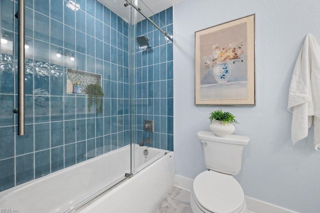 full bathroom with toilet, marble finish floor, baseboards, and enclosed tub / shower combo
