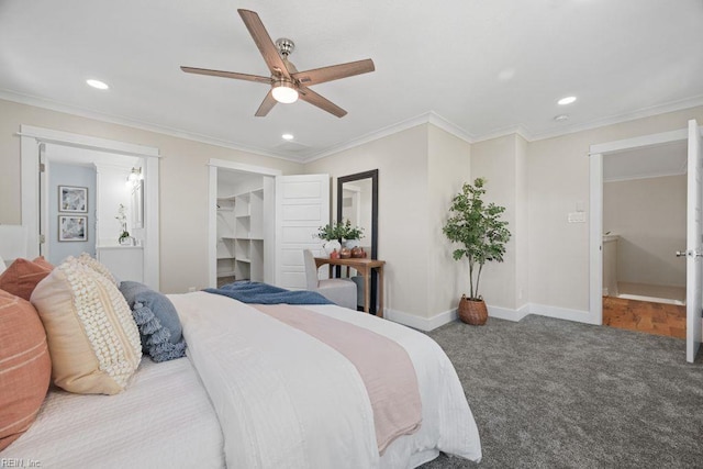 carpeted bedroom featuring baseboards, a spacious closet, a ceiling fan, crown molding, and recessed lighting