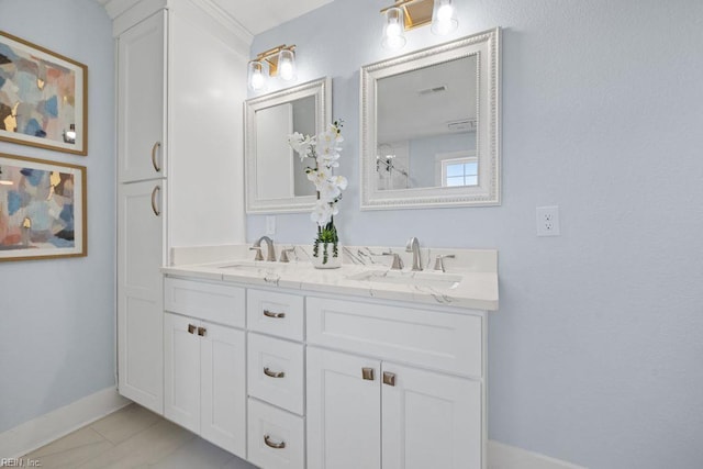 full bathroom with double vanity, visible vents, baseboards, and a sink