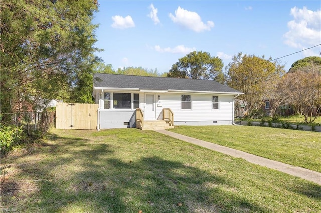 view of front of home with a front yard, fence, and crawl space