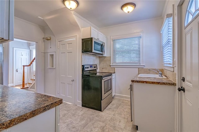 217 Hurley Ave, Newport News, VA 23601 - kitchen featuring backsplash, dark countertops, white cabinets, stainless steel appliances, and a sink