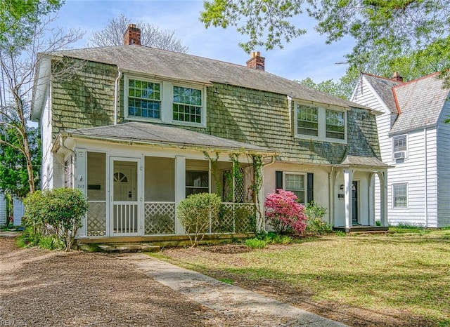 217 Hurley Ave, Newport News, VA 23601 - view of front of property with roof with shingles, stucco siding, a chimney, a front yard, and a gambrel roof