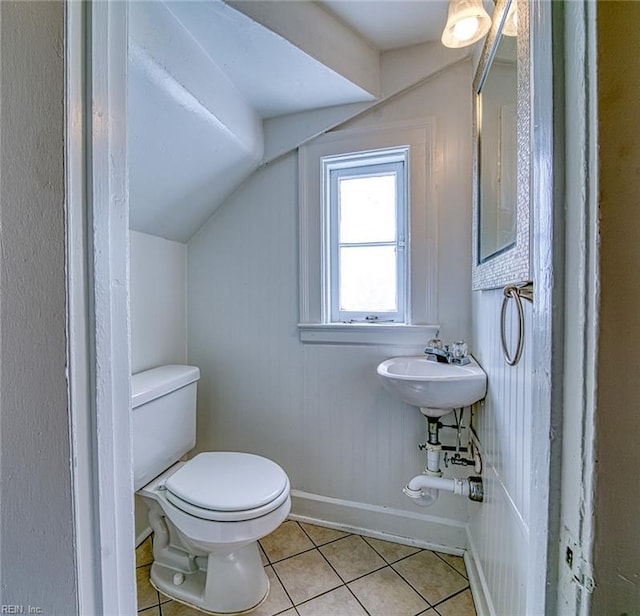 217 Hurley Ave, Newport News, VA 23601 - half bath with baseboards, vaulted ceiling, tile patterned floors, toilet, and a sink