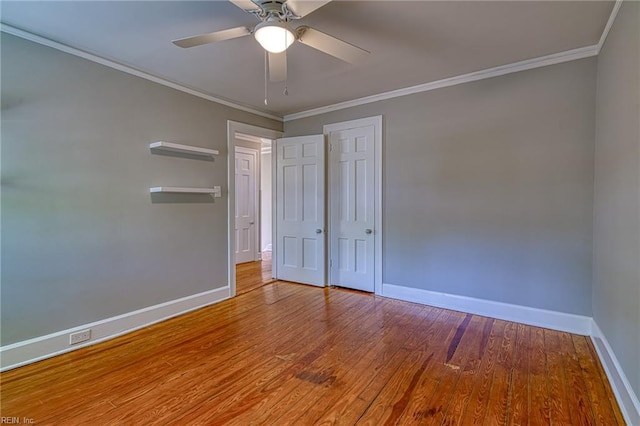 217 Hurley Ave, Newport News, VA 23601 - unfurnished bedroom featuring crown molding, ceiling fan, a closet, wood finished floors, and baseboards