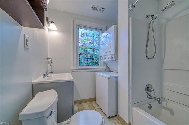 217 Hurley Ave, Newport News, VA 23601 - full bath featuring vanity, visible vents, stacked washer / dryer, toilet, and shower / bathing tub combination