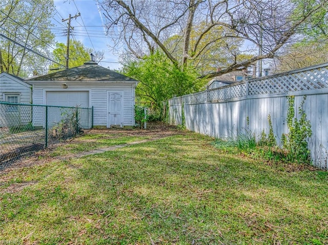 217 Hurley Ave, Newport News, VA 23601 - view of yard featuring a fenced backyard, an outdoor structure, and a detached garage