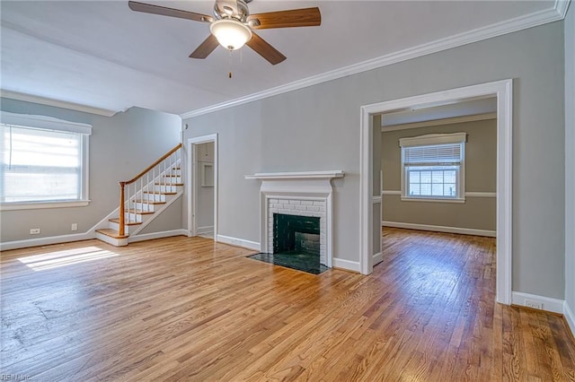 217 Hurley Ave, Newport News, VA 23601 - unfurnished living room featuring stairs, a brick fireplace, ornamental molding, and a ceiling fan