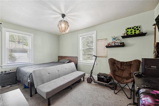 carpeted bedroom featuring a textured ceiling