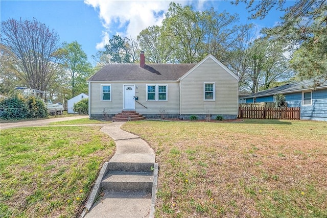 bungalow-style home featuring a front yard, entry steps, fence, and a chimney