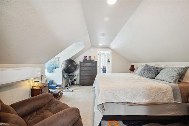 bedroom with carpet floors and lofted ceiling