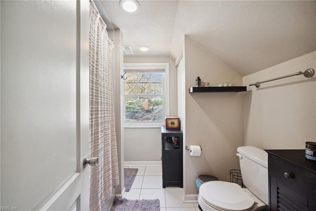 full bathroom featuring a textured ceiling, tile patterned flooring, vaulted ceiling, toilet, and baseboards