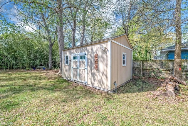 view of outdoor structure with an outbuilding and fence